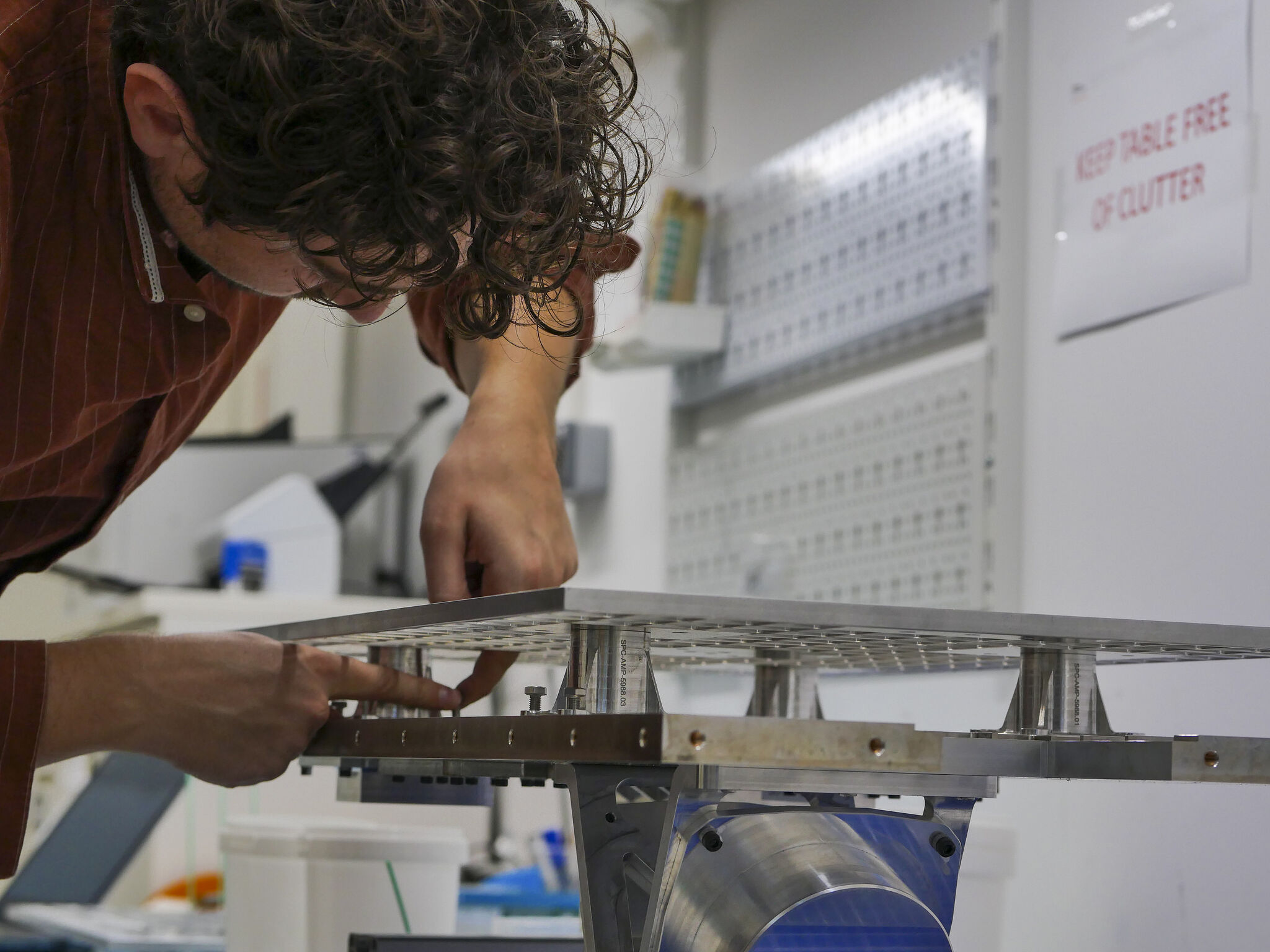 An Infinite Orbits engineer assembling spacecraft hardware